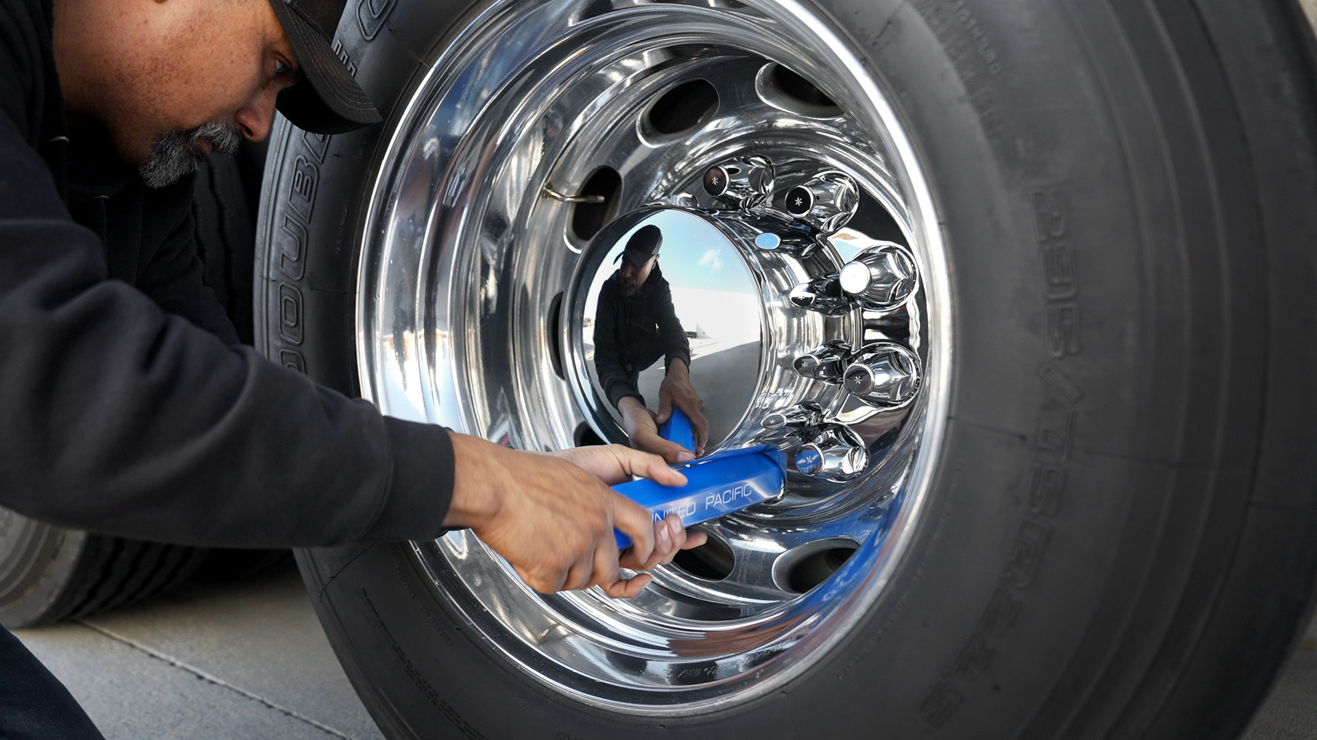 Man Turning Nut Cover and Wheel